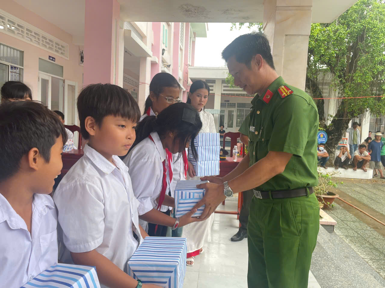 Ảnh 1 Đồng chí Trung tá Bùi Văn Tế, Trưởng Công an trao quà cho các em học sinh tại Trường Tiểu học Đại An A